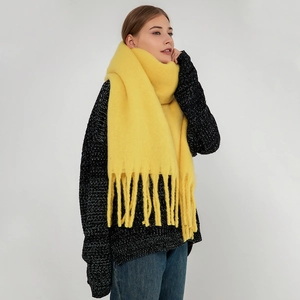 Soft bright yellow mohair scarf with tassels and thick knit texture for winter warmth