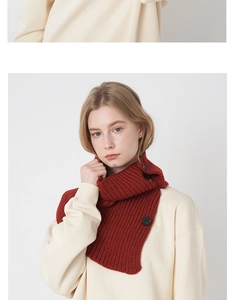 Detail of red wool-blend knit neck warmer with black buttons on a female model