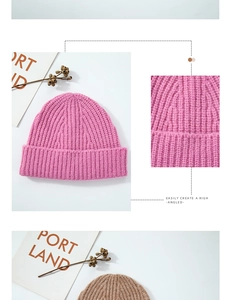 Detail of chunky ribbed knit wool beanies in pink and brown with fold-over cuff