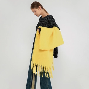 Soft bright yellow mohair scarf with tassels shown on a model for cozy winter warmth
