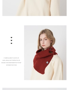 Detail of dark red wool knit neck warmer featuring elegant black button closures