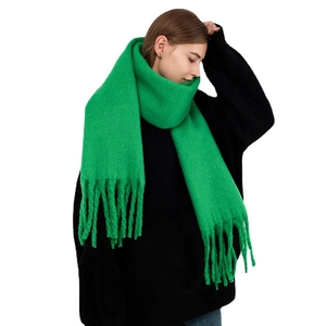 Vibrant green chunky knit scarf with tassels made of soft cashmere-like mohair material