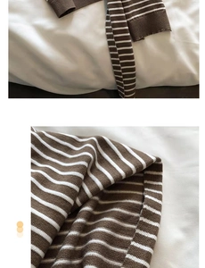 Detailed view of brown and white striped knit fabric texture with soft ribbed cuffs