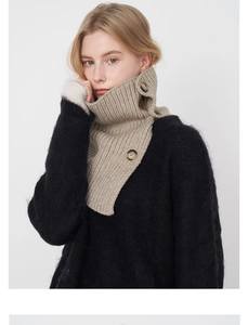 Detail view of khaki wool knit neck gaiter with large buttons and textured knit pattern