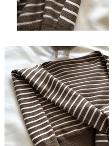 Close-up of brown and white striped knit shawl texture with detailed ribbed hem