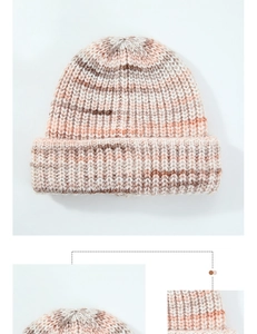 Detailed view of the thick knit texture and top stitching on this pink wool beanie