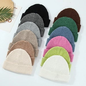 Collection of colorful knitted wool beanies in various solid colors for outdoor warmth