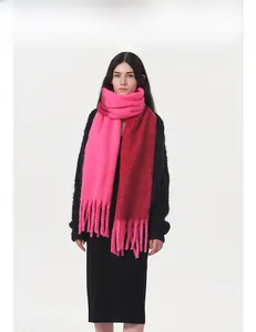 Close-up of thick pink and burgundy bicolor mohair scarf with elegant long tassels