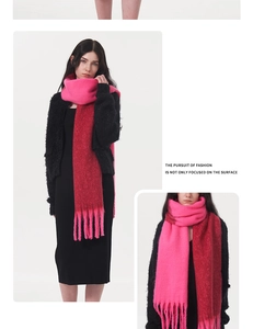 Detail of soft gradient pink to plum cashmere-like knit scarf with long decorative fringe