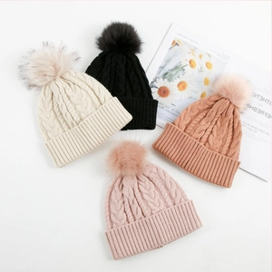 Chunky wool-blend cable knit beanies with faux fur pom-poms in four neutral winter colors