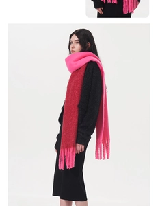 Detail of soft mohair scarf showing fringe and vibrant pink to dark red gradient color