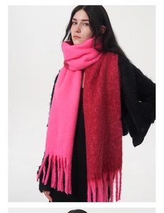 Detail of soft pink and dark red faux cashmere scarf with chunky tassels and brushed texture