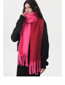 Detailed macro view of two-tone gradient knit scarf with long fringes and soft texture