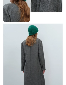 Detail of grey wool blend herringbone coat fabric and green textured knit beanie hat