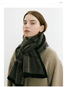 Close-up of thick knit scarf with black and brown geometric checkered pattern texture