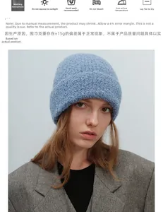 Detailed view of blue bouclé knit texture and thick ribbed cuff on a warm winter beanie