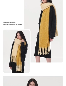 Detail view of thick two-tone mohair scarf with tassels in off-white and bright yellow