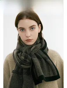 Close-up of thick winter knit scarf featuring classic houndstooth patterns in black and beige