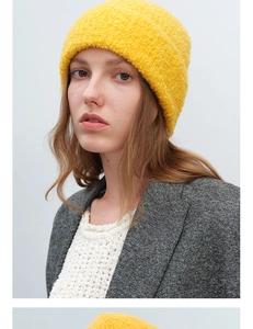 Detail of yellow wool knit beanie with textured boucle fabric for autumn and winter