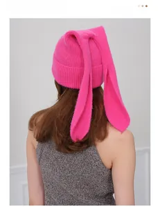 Detail of soft rose pink knitted beanie with long floppy rabbit ears from the back view