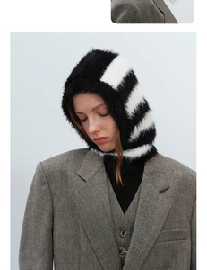 Detail of soft black and white striped plush faux fur balaclava hood texture