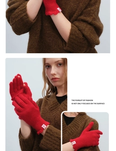 Detail of red wool-blend fingerless gloves featuring knit texture and touch-screen cutouts