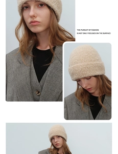 Detailed texture of beige boucle wool knit beanie showing thick warm fabric and cozy fit