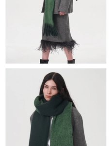 Detail of green knit scarf with soft mohair texture and elegant feather tassel hem