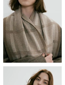 Close-up of thick checkered knit scarf showing detailed brown houndstooth texture and weave