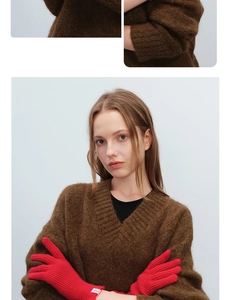 Close-up of red knitted fingerless wool gloves showing rich texture and soft knit lace