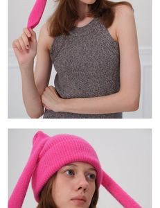 Detail of bright pink Y2K bunny ear knitted hat with soft plush texture for winter warmth