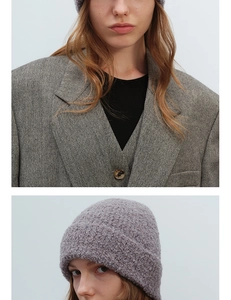 Close-up of gray knit beanie showing textured boucle yarn fabric and soft wool feel