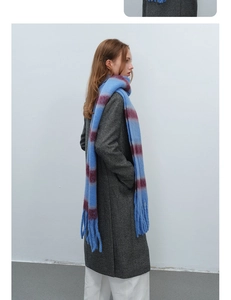 Detail of blue and maroon striped thick knit scarf with soft mohair texture and long tassels