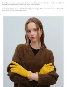Detail of yellow wool knit gloves featuring ribbed texture and stylish brand label