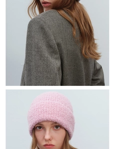 Detailed texture view of a pink chunky knit beanie showing soft wool blend material