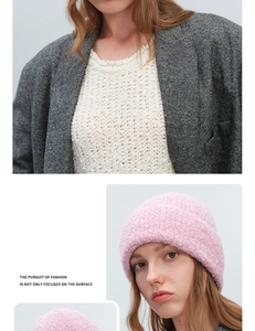 Detail of pink curly yarn knit beanie showing thick texture and wool-like material