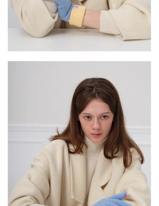 Close-up of wool knit gloves in blue and beige patchwork with a minimalist brand label
