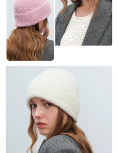 Close-up of soft textured wool blend boucle knit beanie hat in pink and cream beige