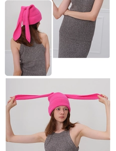 Detail view of hot pink knitted Y2K beanie with long rabbit ears and fluffy texture