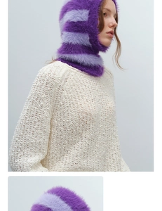 Detail of purple striped faux fur balaclava paired with cream chunky knit sweater