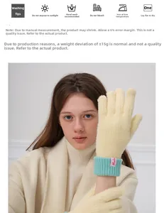 Detail view of beige wool knit gloves with mint green ribbed cuffs and red brand label