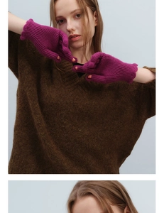 Detail of wool knit fingerless gloves in magenta with ribbed texture and scalloped cuffs