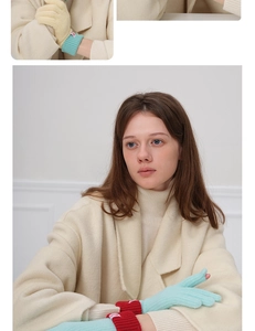 Detail of wool knit gloves featuring elastic ribbed cuffs and decorative brand woven label