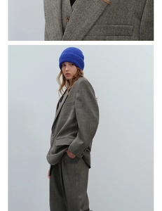 Detailed view of grey herringbone wool fabric texture and stylish knit beanie combo