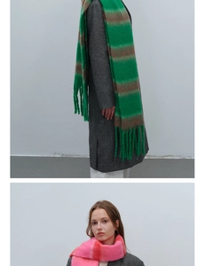 Detail view of thick mohair-style striped scarf with long tassel fringe and soft texture