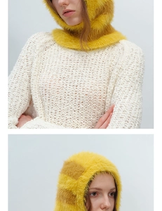 Detail of yellow checkerboard faux fur balaclava hood paired with a white knit sweater