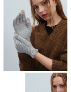 Detail of light gray wool knit gloves with touchscreen finger holes and ribbed texture