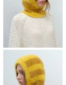 Detailed view of yellow and brown striped faux mink balaclava hood on knitwear