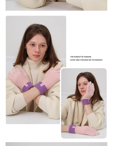Detail of pink and purple knit gloves with tactile texture and branded wrist label