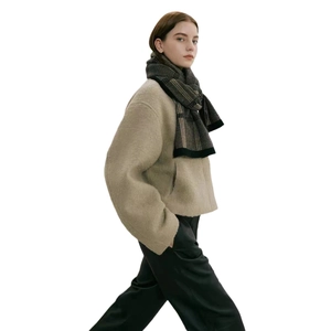 Classic checkered knit scarf for men and women shown on a model with a cozy winter jacket